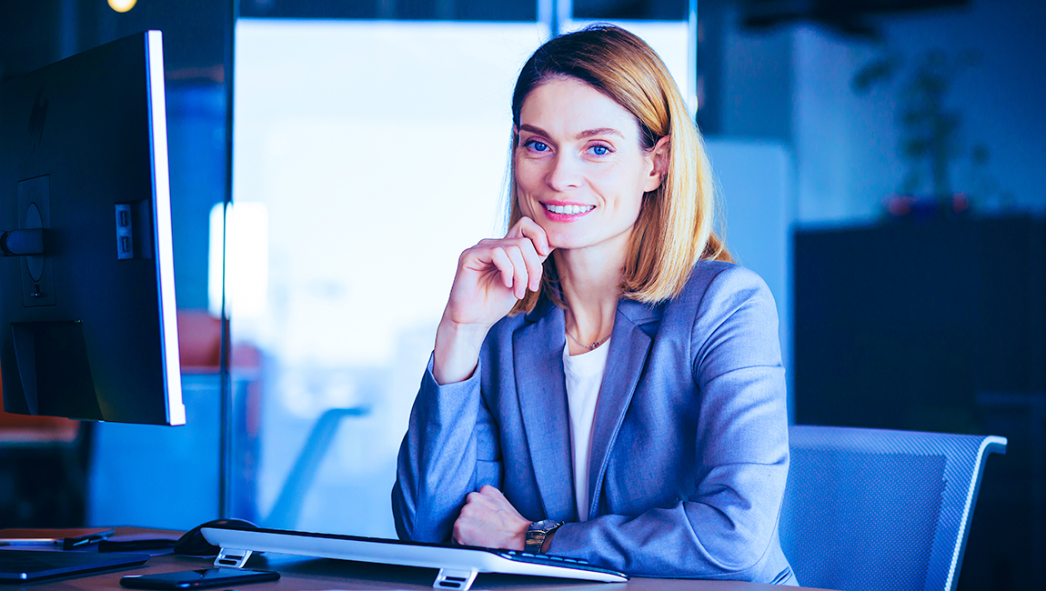 Businesswoman smiling at her desktop