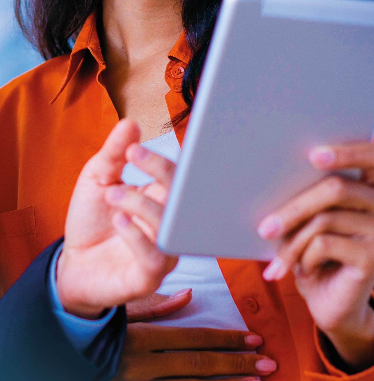 Mosaic image of two colleagues smiling and looking at tablet